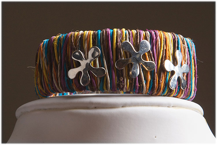 small ethnic straw cuff with sterling silver flowers and closure